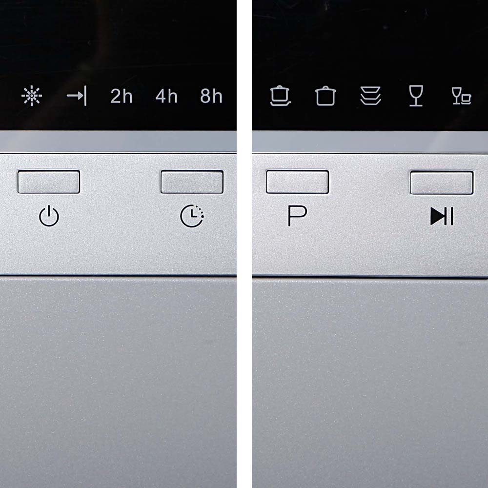 Control panel with time settings and various icons on a metallic surface.