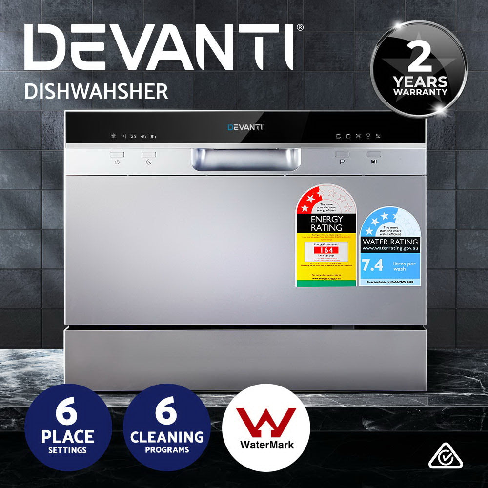 Devanti dishwasher with rating labels and warranty information on a dark tiled background