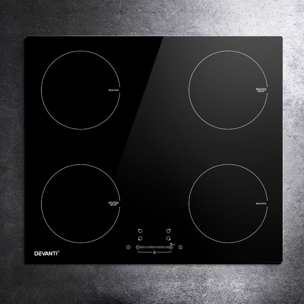 Black glass cooktop with four heating elements on a gray surface, featuring the Devanti brand.