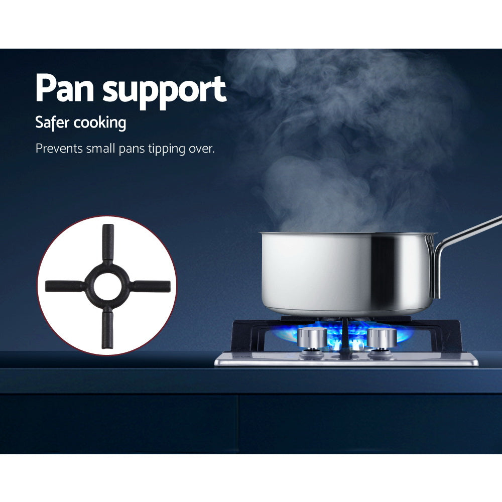 Durable cast iron trivets supporting pans over the Devanti gas burners.