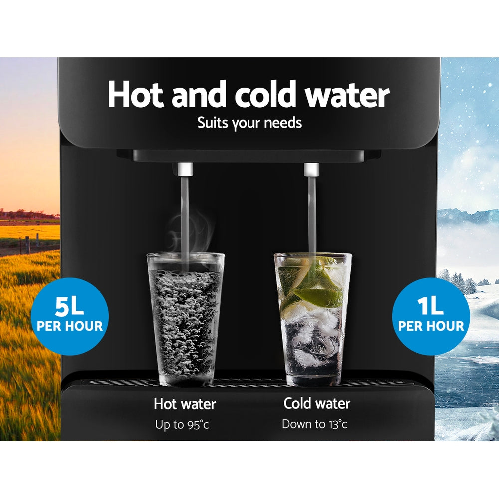 Close-up of the dual taps dispensing both hot and cold water.