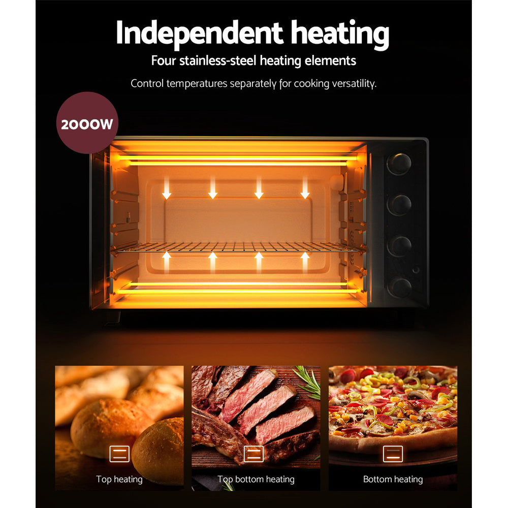 Chicken roasting inside the Devanti oven with the built-in light turned on.