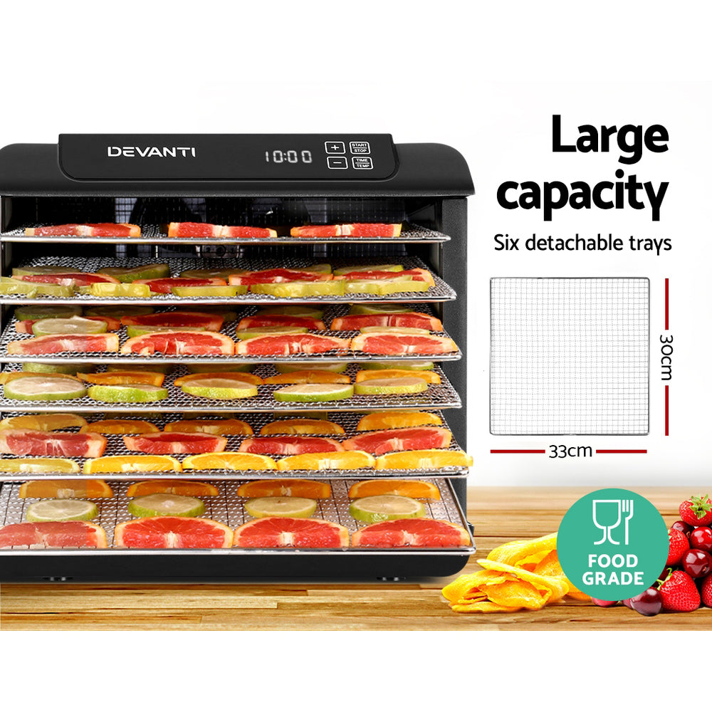 The dehydrator in use with trays filled with sliced fruits and meats, showing spacious and organized drying.