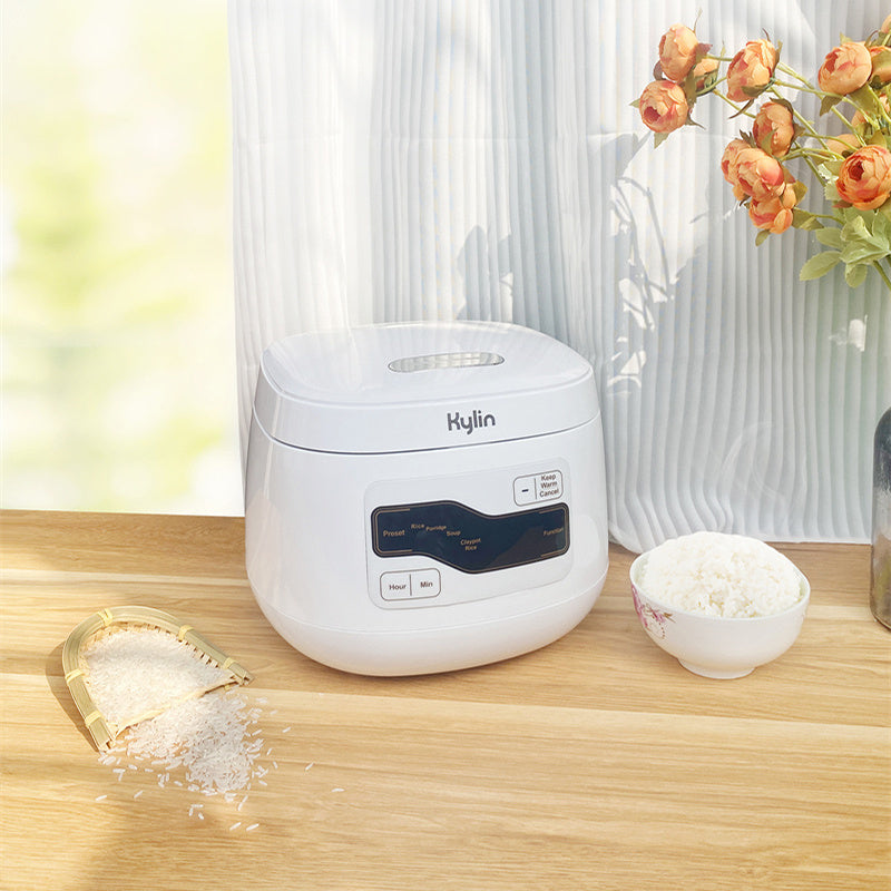 Complete setup of the Kylin 2L Rice Cooker with ceramic pot, lid, and accessories.
