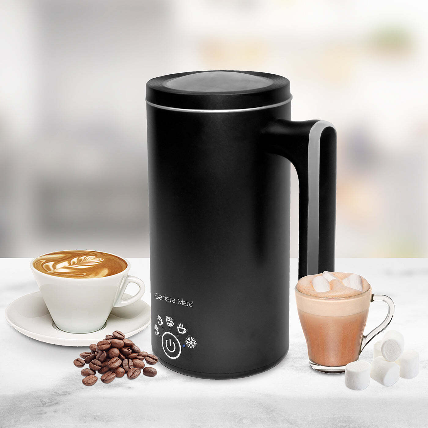 Hot milk frothing inside black milk frother jug