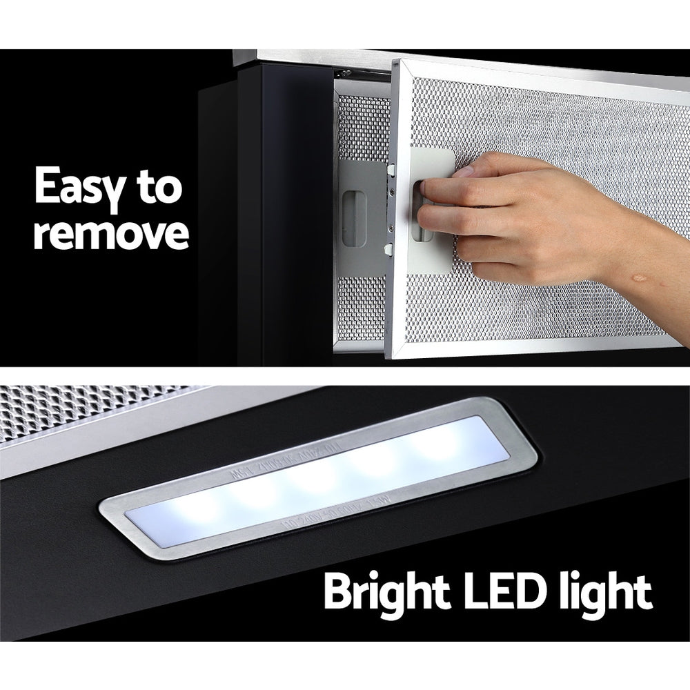A hand pulling the Devanti range hood out, demonstrating the auto on/off slide mechanism. No model face shown.