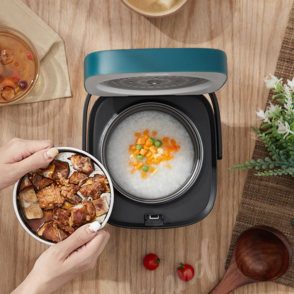 Small rice cooker filled with freshly cooked fluffy white rice.