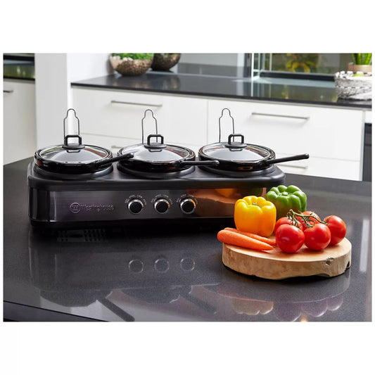 Triple burner cooktop with vegetables on a kitchen counter