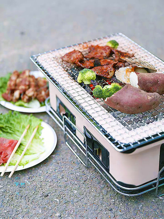 Portable grill with food on a gray surface