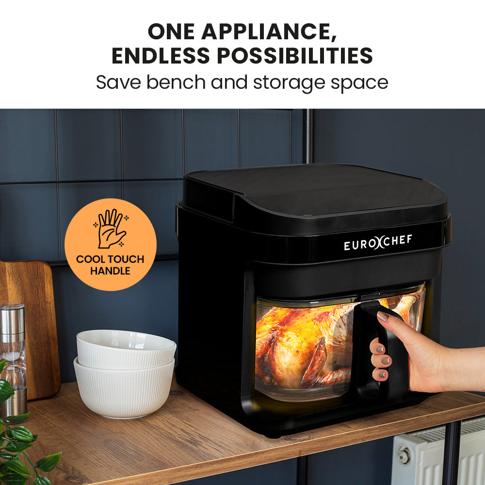 Black Eurochef appliance with a hand holding it, showing a roasted chicken inside, on a kitchen counter.