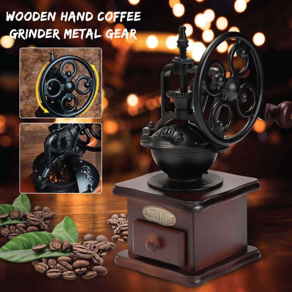 Vintage-style wooden hand coffee grinder with metal gear on a dark background with blurred lights.