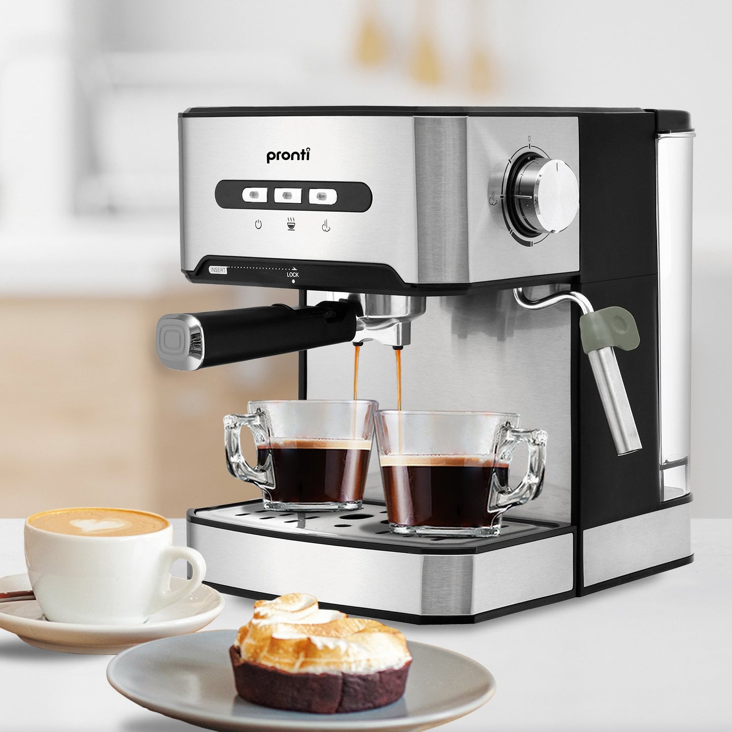 Espresso machine with two cups of coffee and a dessert on a white surface.