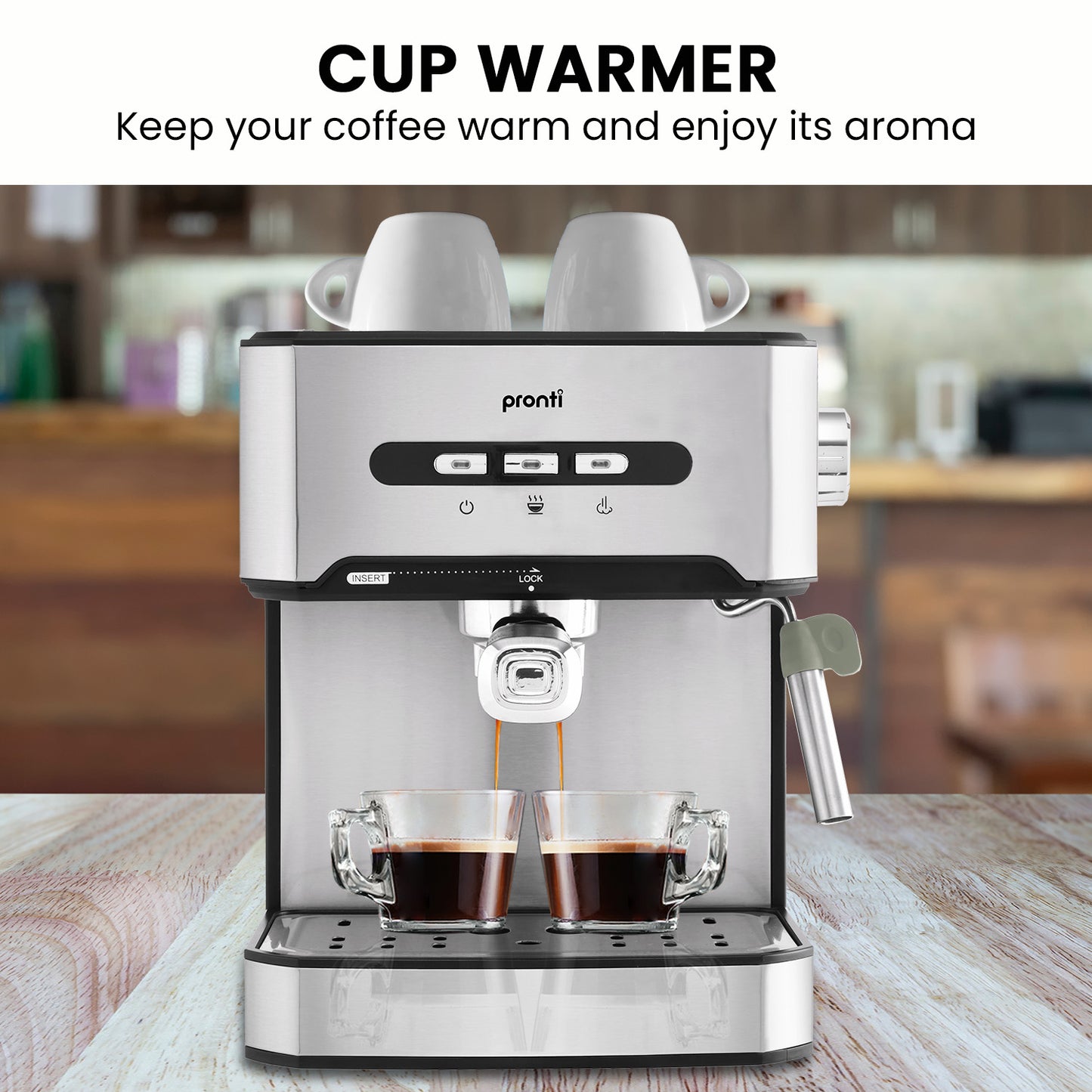 Pronti coffee machine with two cups of coffee being warmed, set against a blurred kitchen background.
