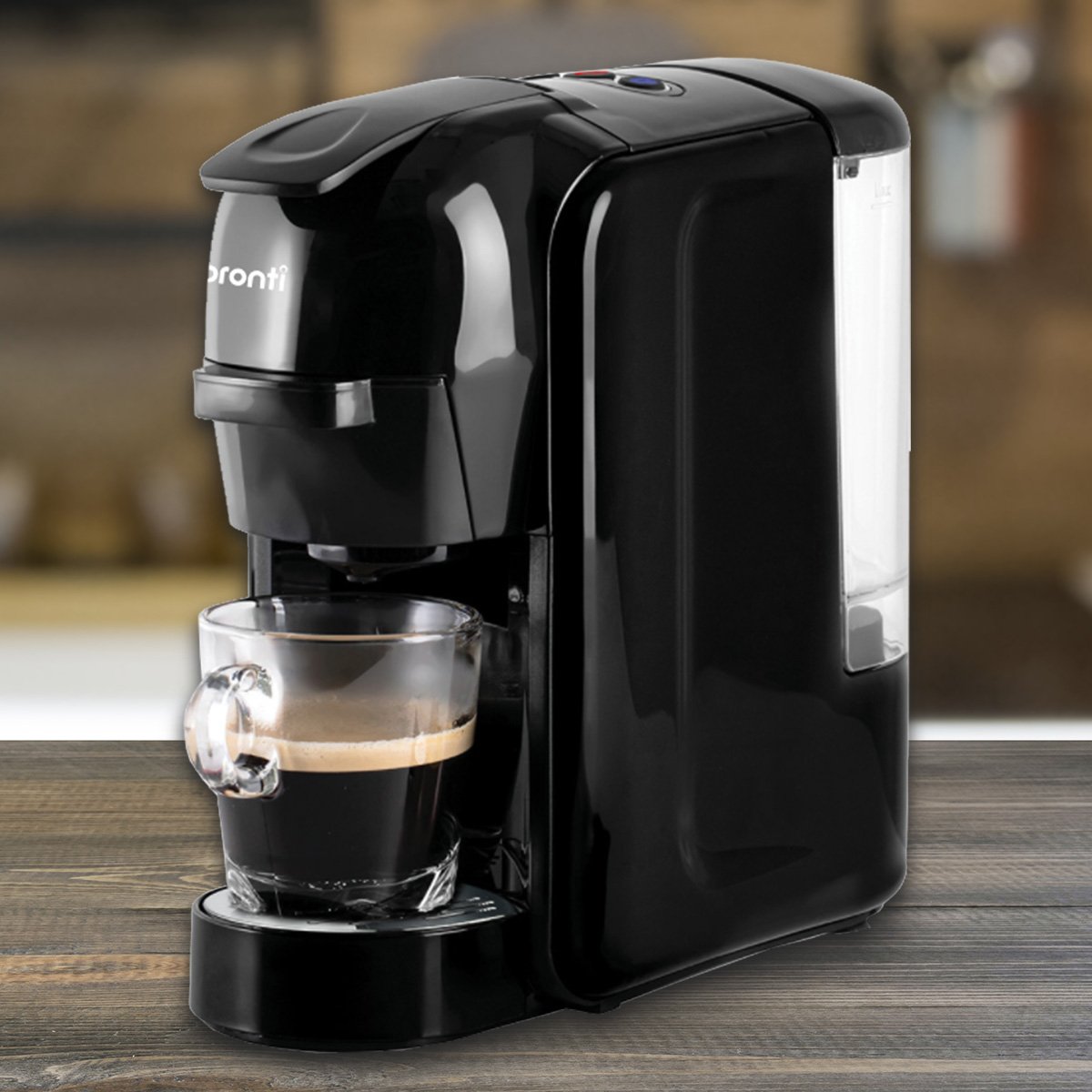 Black coffee machine with a glass cup on a wooden surface