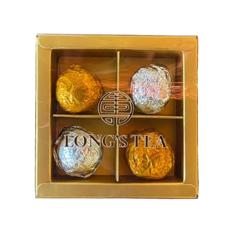Gold box containing four tea balls with 'Long's Tea' branding on a white background