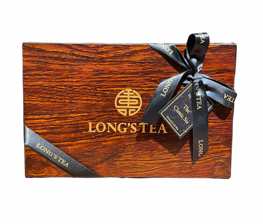 Wooden box with a black ribbon and 'Long's Tea' branding on a white background