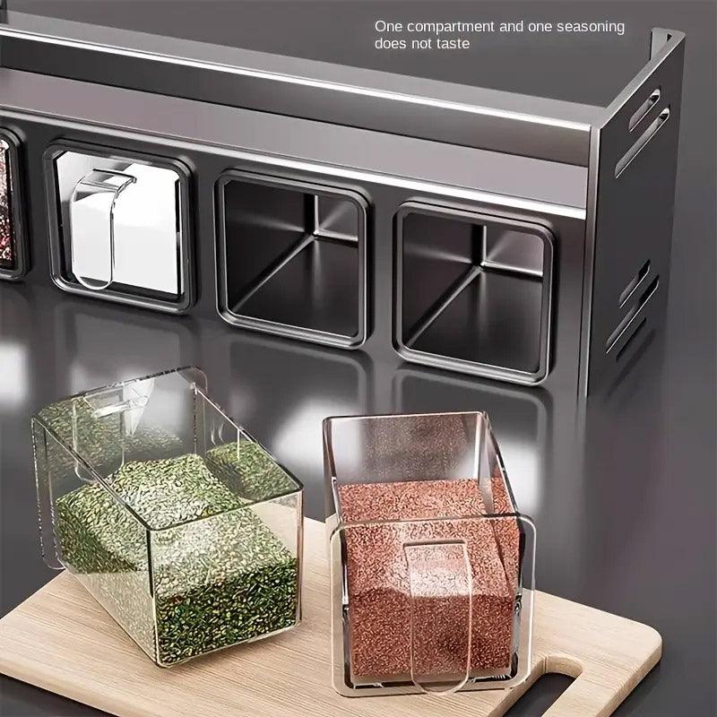 Kitchen seasoning container set with transparent compartments on a wooden cutting board.