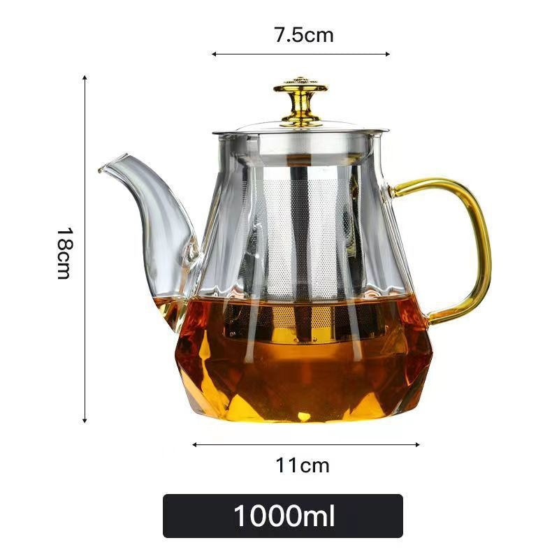 Glass teapot with gold handle and spout, filled with tea, showing dimensions on a white background.