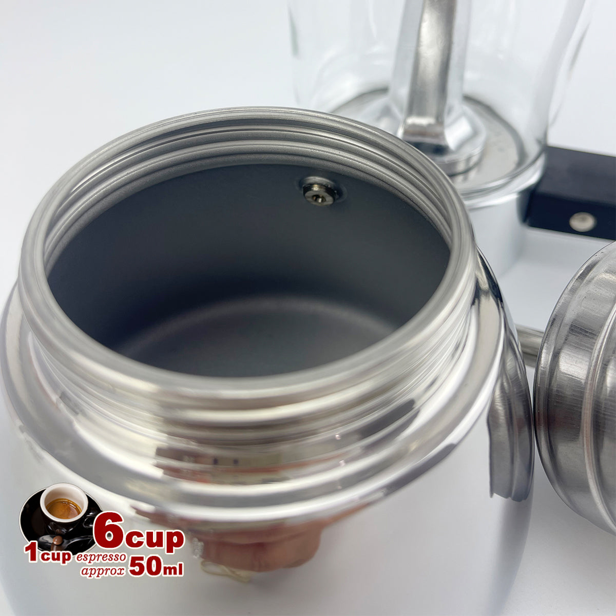 Close-up of a stainless steel coffee grinder with a 6 cup and espresso conversion label.