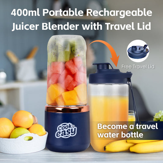 Portable rechargeable juicer blender with travel lid and fruits on a kitchen counter.