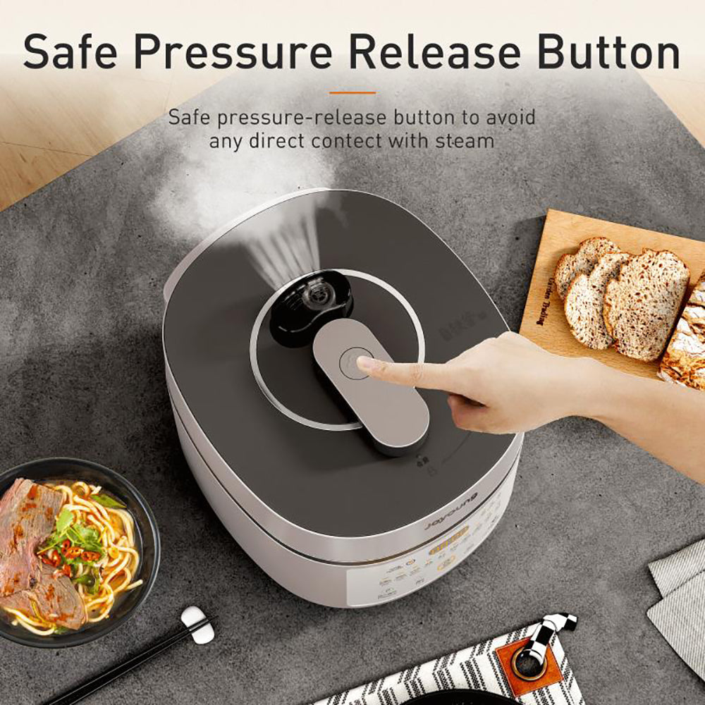 Electric pressure cooker with a safe pressure release button on a kitchen counter, surrounded by food items.