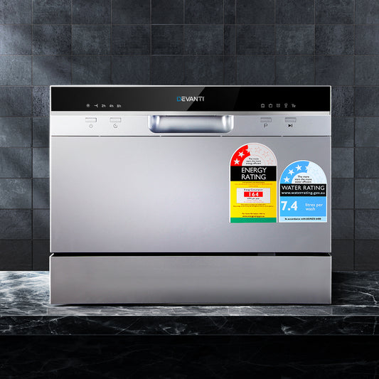 Stainless steel dishwasher with energy and water rating labels on a tiled wall background