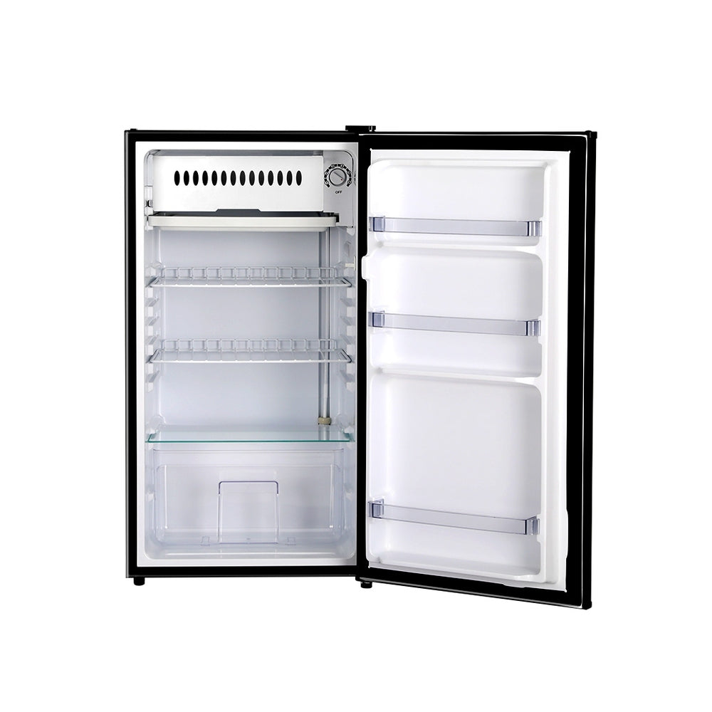 Small refrigerator with open door on a white background