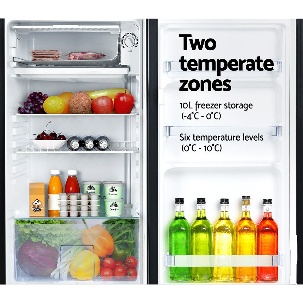 Refrigerator with open door displaying food items and text about temperature zones.