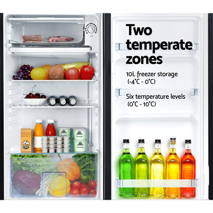 Refrigerator with open door displaying food items and text about temperature zones.