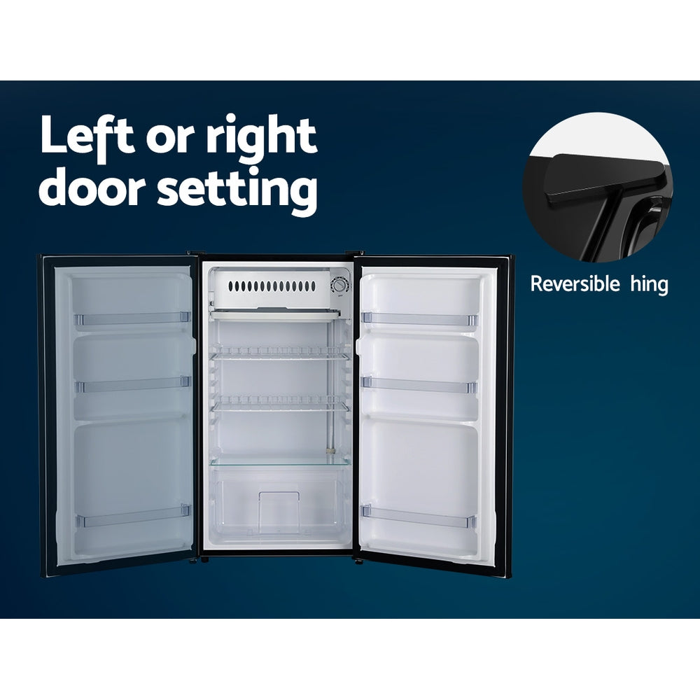 Open refrigerator with reversible hinge feature on a blue background