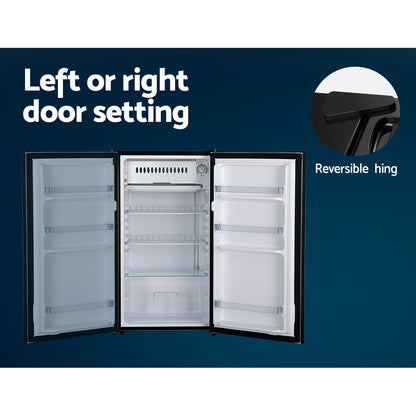 Open refrigerator with reversible hinge feature on a blue background