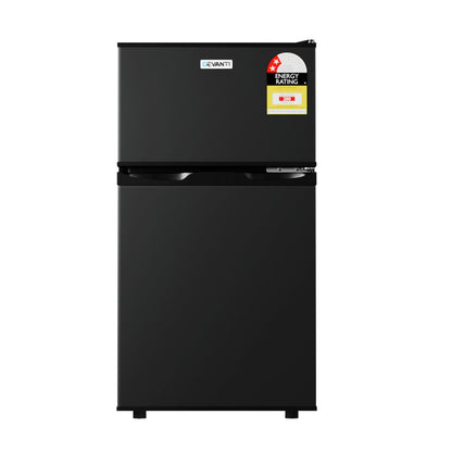 Black refrigerator with energy rating labels on a white background