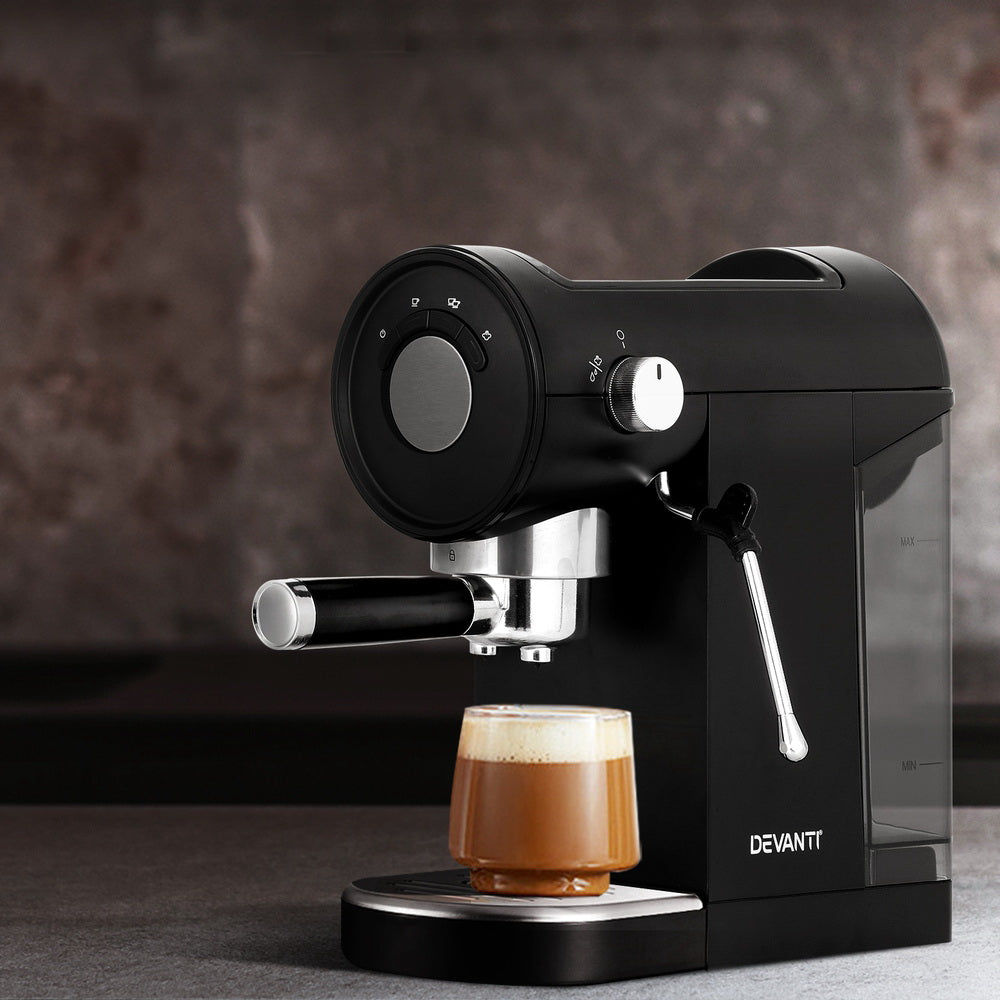 Black espresso machine with a glass of coffee on a dark background