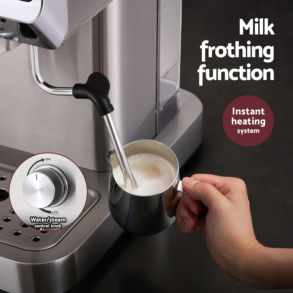 Coffee machine with milk frothing function and a hand holding a cup of frothed milk.