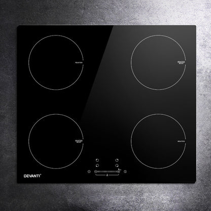 Black glass cooktop with four heating elements on a gray surface, featuring the Devanti brand.