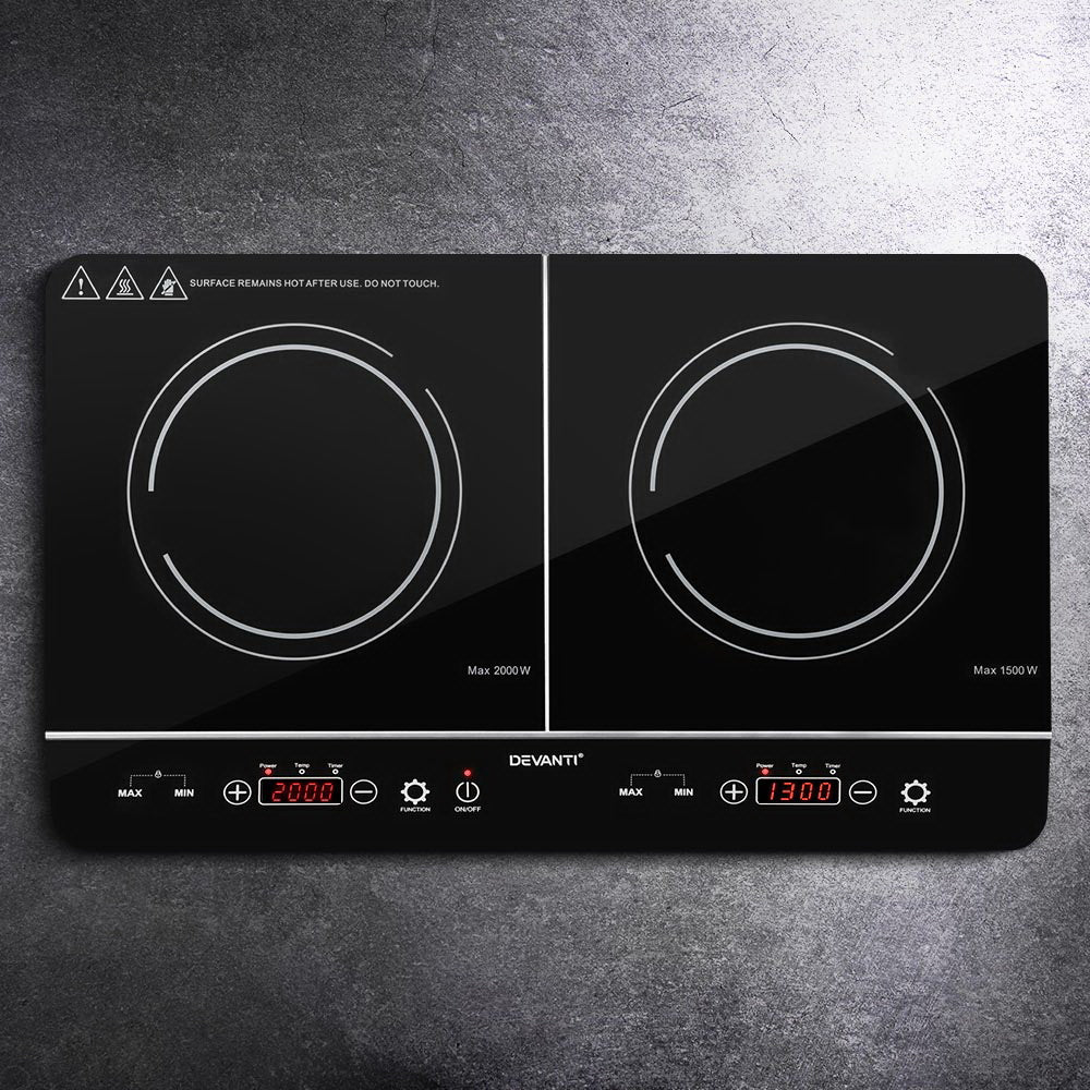 Two induction cooktop burners on a dark surface with 'Devanti' branding.
