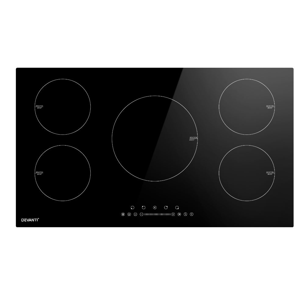 Black induction cooktop with four heating zones on a white background