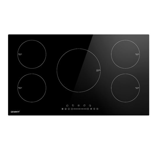 Black induction cooktop with four heating zones on a white background