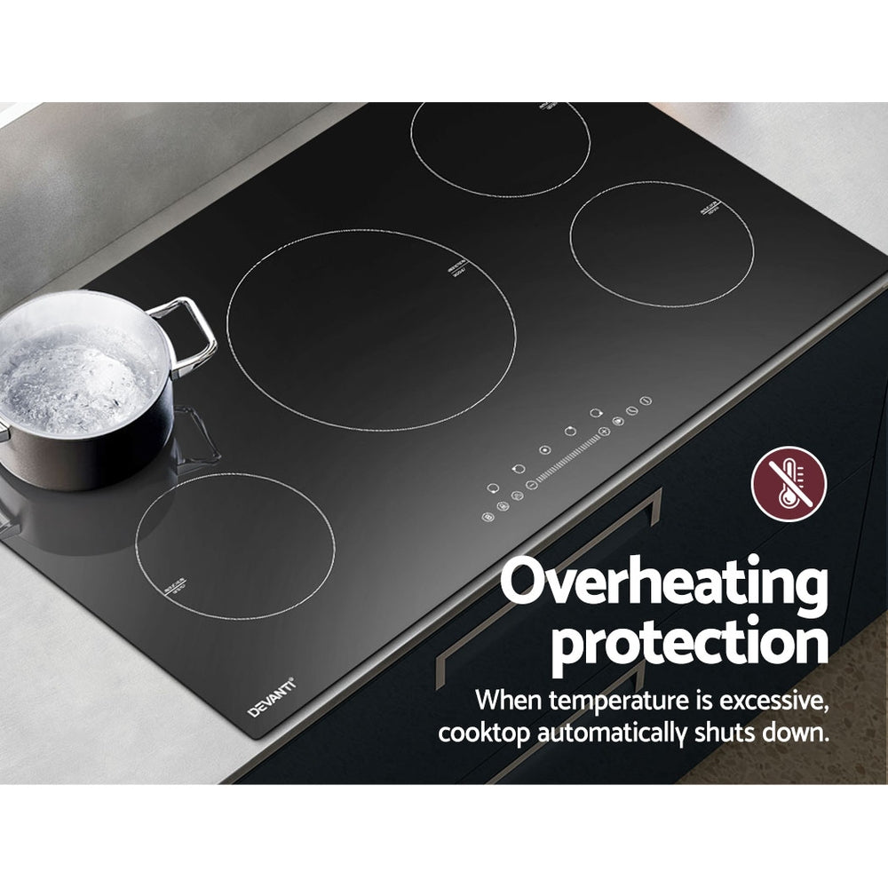 Black induction cooktop with pot of boiling water, featuring overheating protection text.