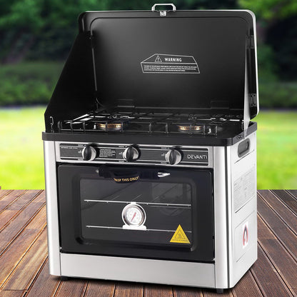 Devanti portable gas oven cooking meal outdoors with scenic background