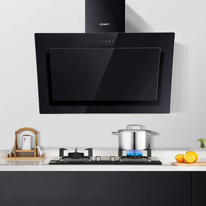 Full kitchen installation showing the Devanti angled black range hood mounted above a stove. Model RH-90-BK.
