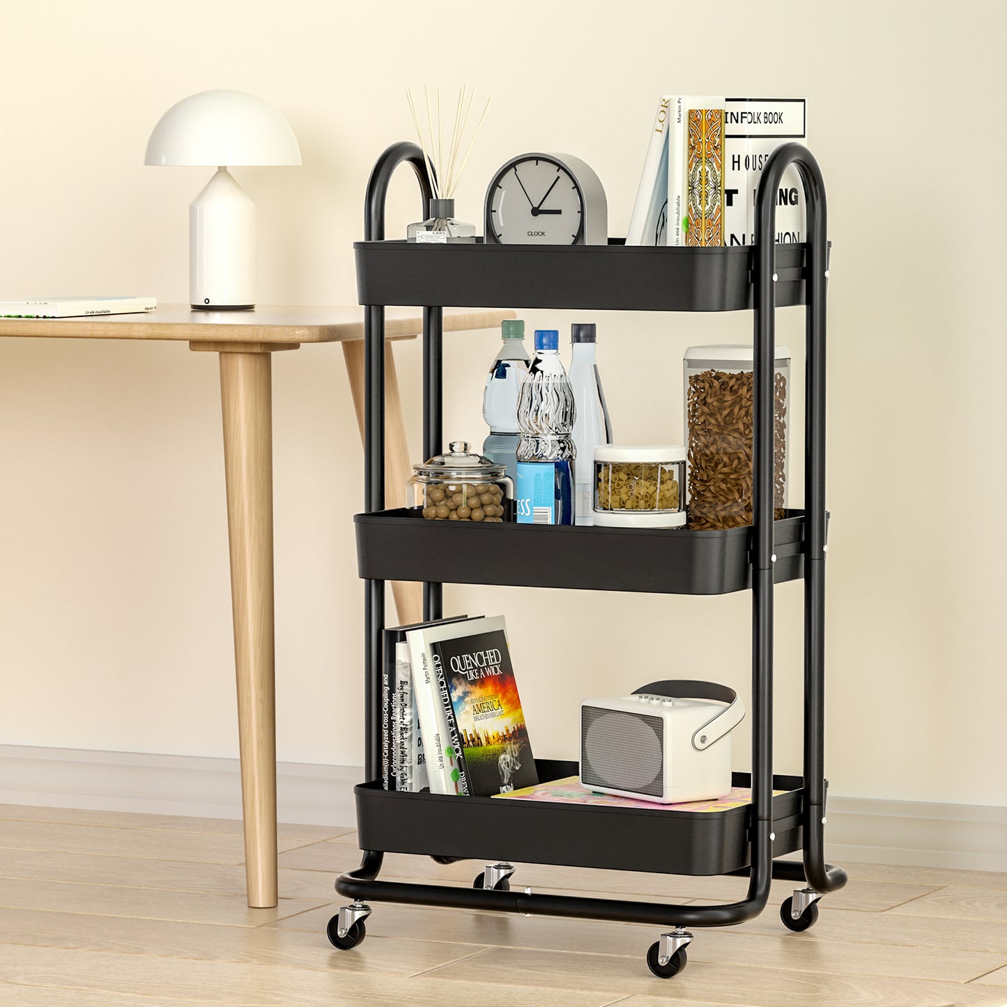 Black three-tier rolling cart with various items in a room setting.