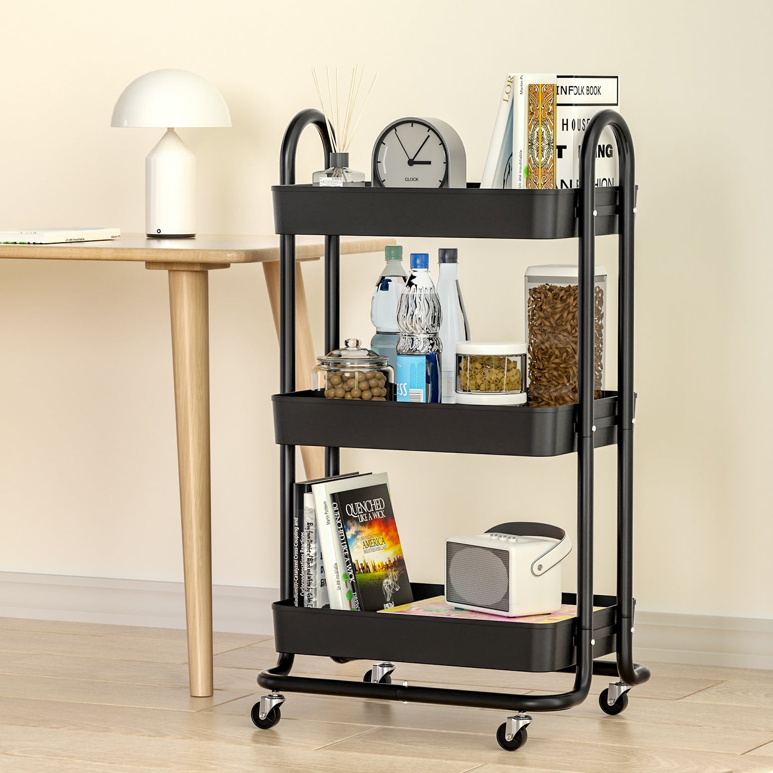 Black three-tier rolling cart with various items in a room setting.