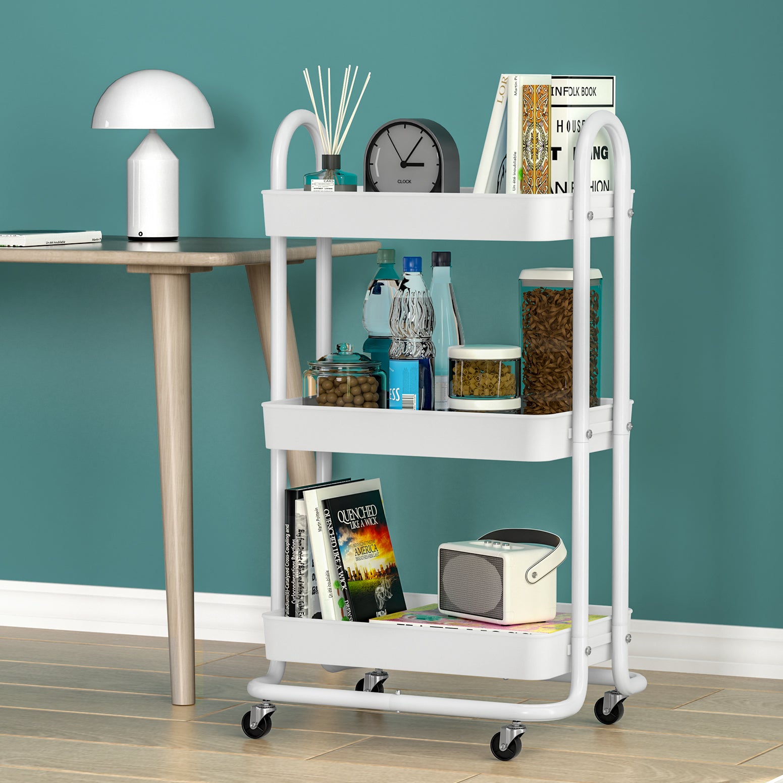 White rolling cart with various items against a teal wall
