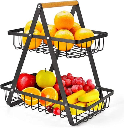 Two-tiered metal fruit basket with fruits on a white background