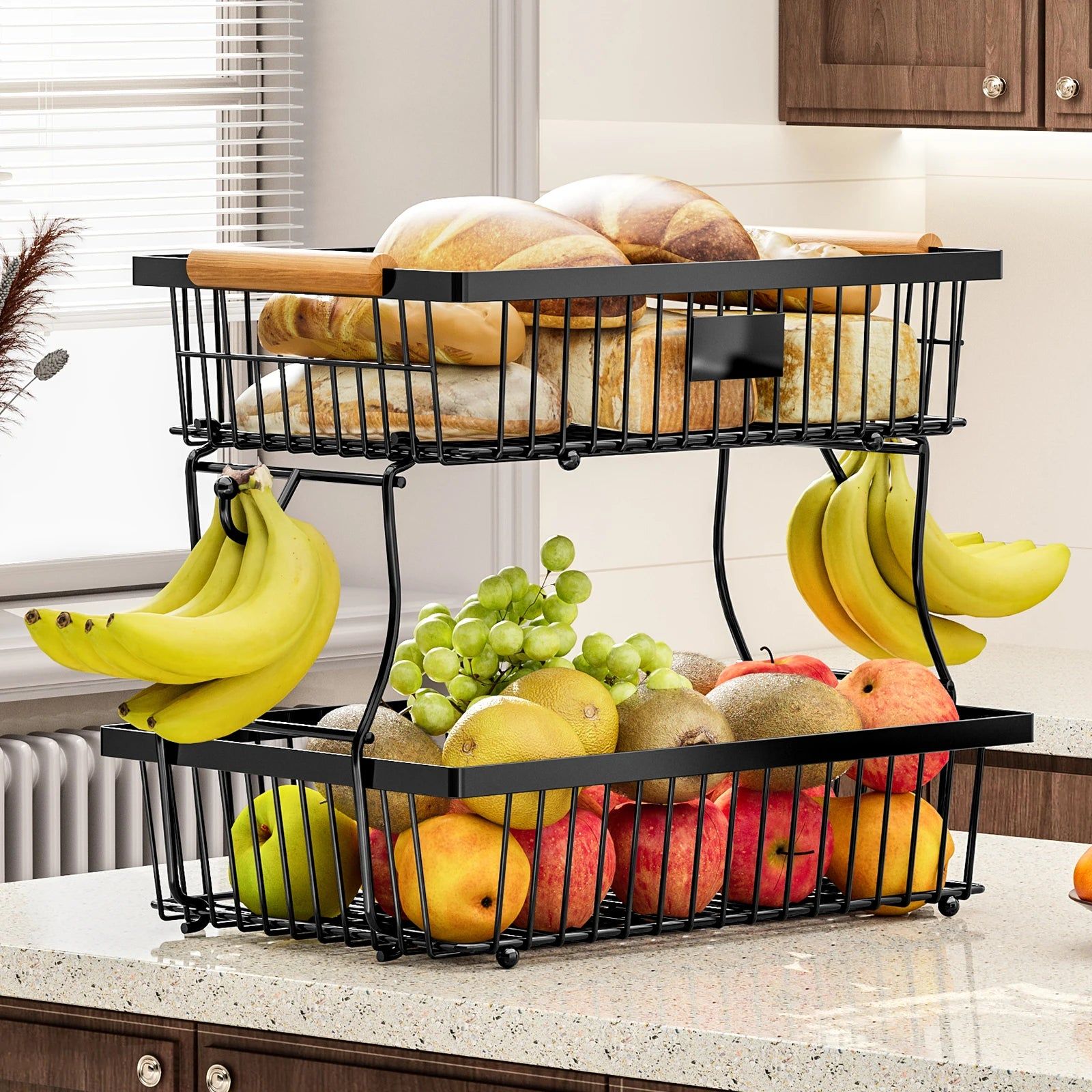 Two-tier fruit and bread basket with fruits and bread on a kitchen counter.