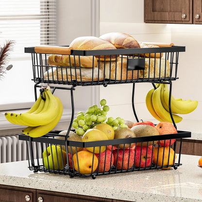 Two-tier fruit and bread basket with fruits and bread on a kitchen counter.