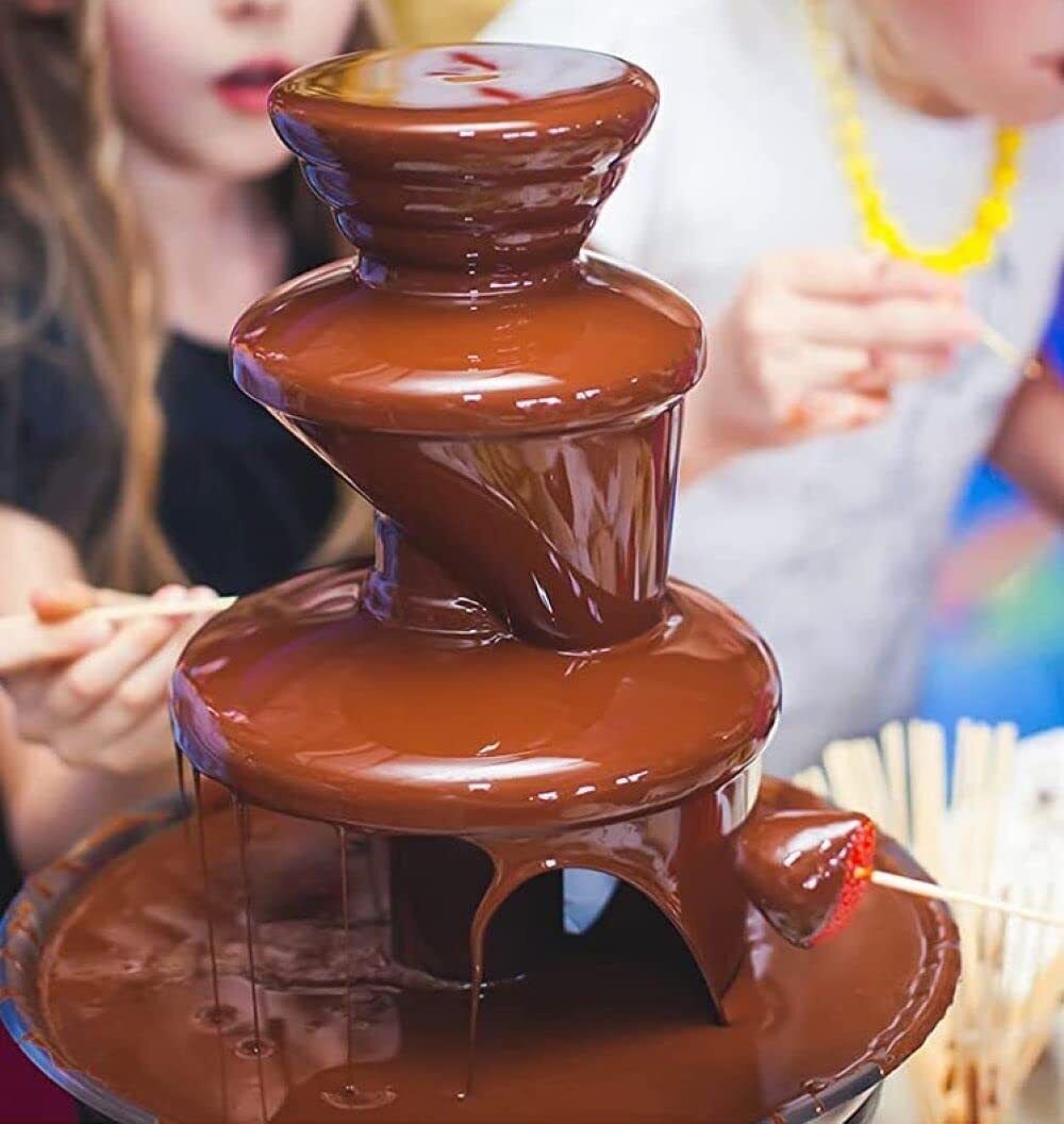 Chocolate fountain with people in the background
