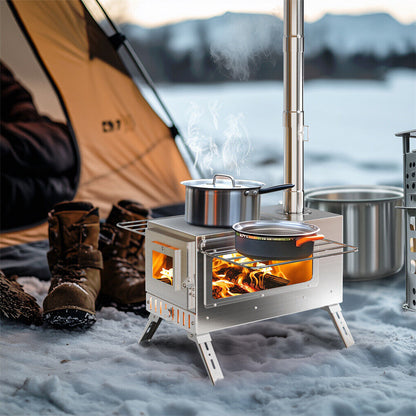 Camping stove with pots on a snowy ground near a tent and boots, with a scenic background.