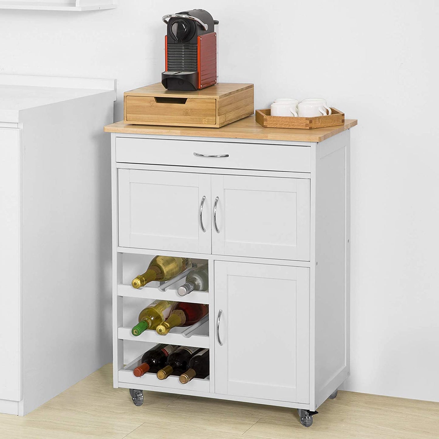 White kitchen island with wooden top, storage compartments, and wine bottles.